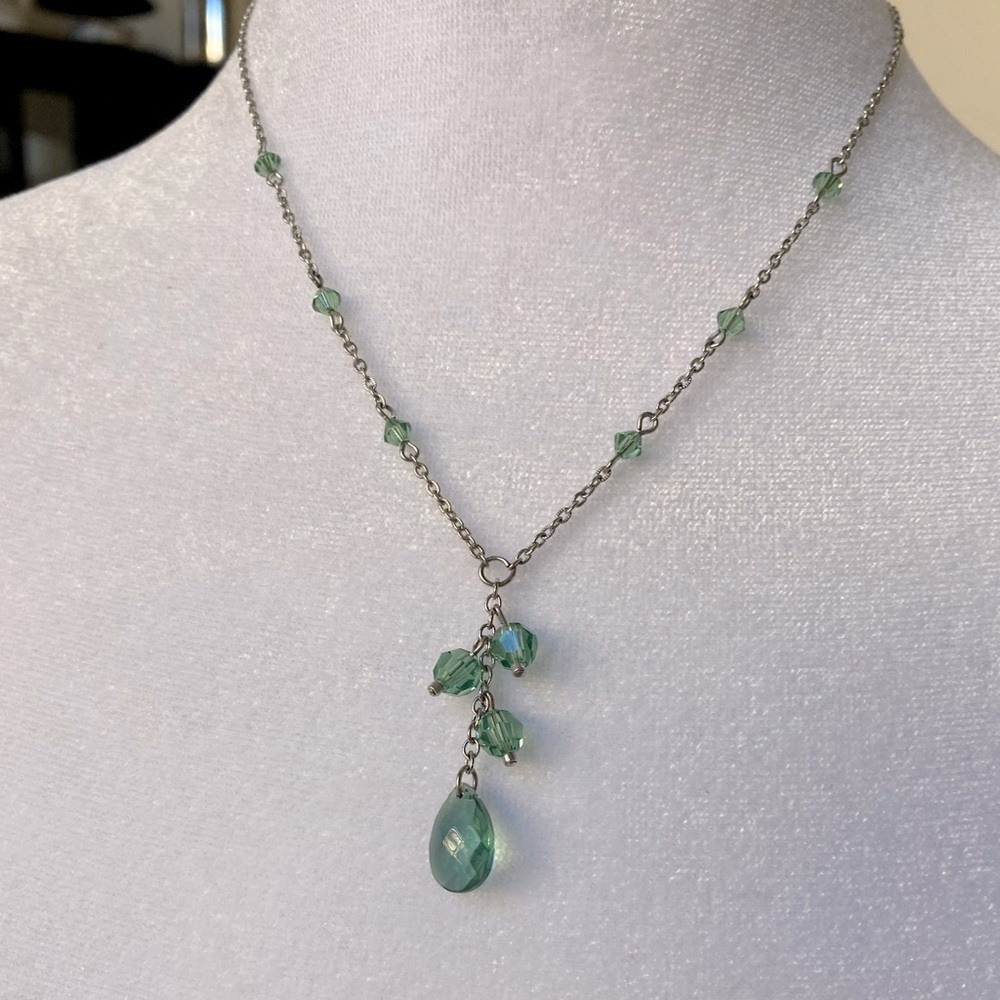 Green jeweled necklace on silver tone chain. 12” long when worn.  Good condition
